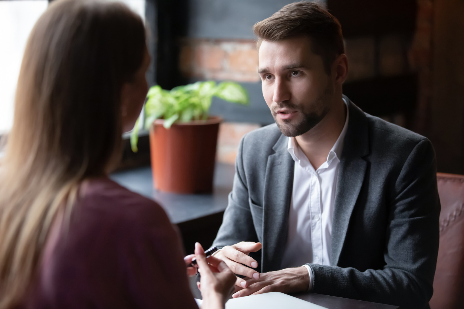 Diverse businesspeople meeting in cafe discussing collaboration